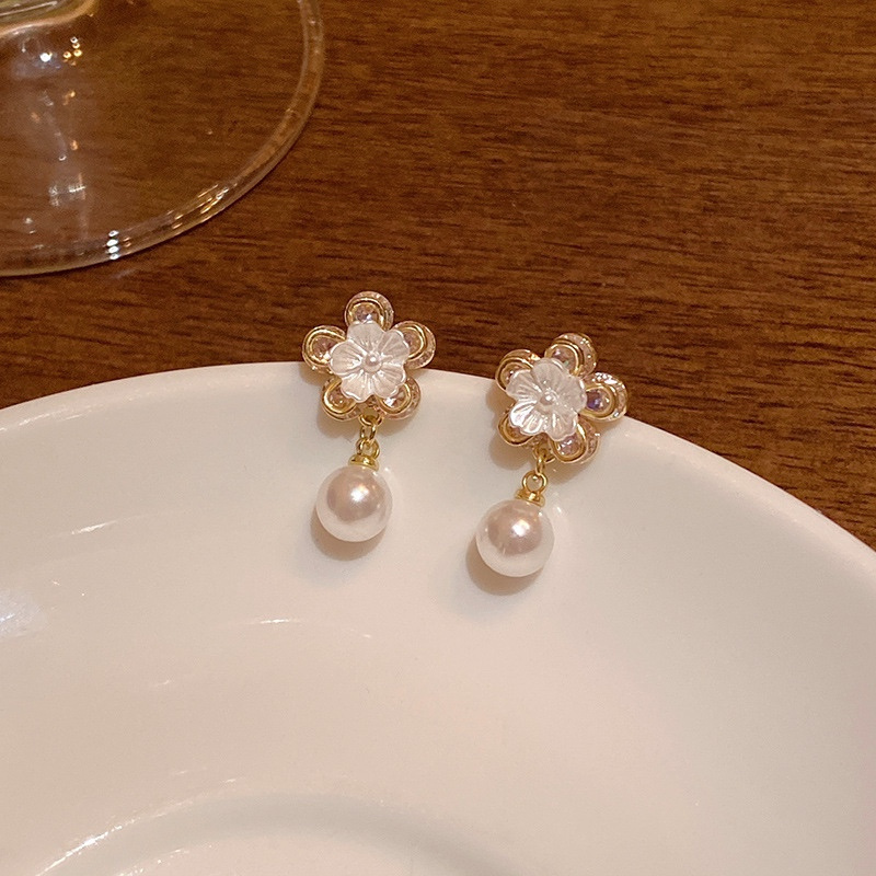 Gold flower pearl drop earrings product display