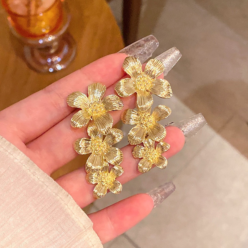 Gold Triple Flower Drop Earrings Handheld View