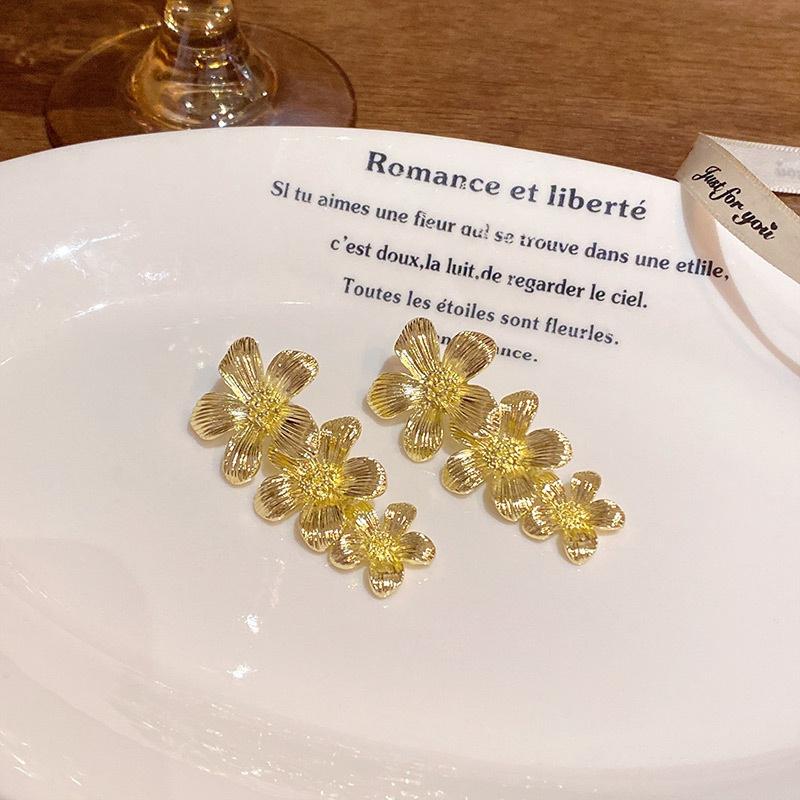 Gold Triple Flower Earrings Lifestyle Display
