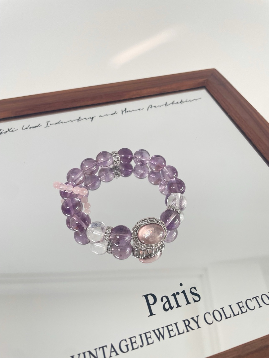 Elegant Amethyst Kunzite and Clear Quartz bracelet displayed on jewelry frame