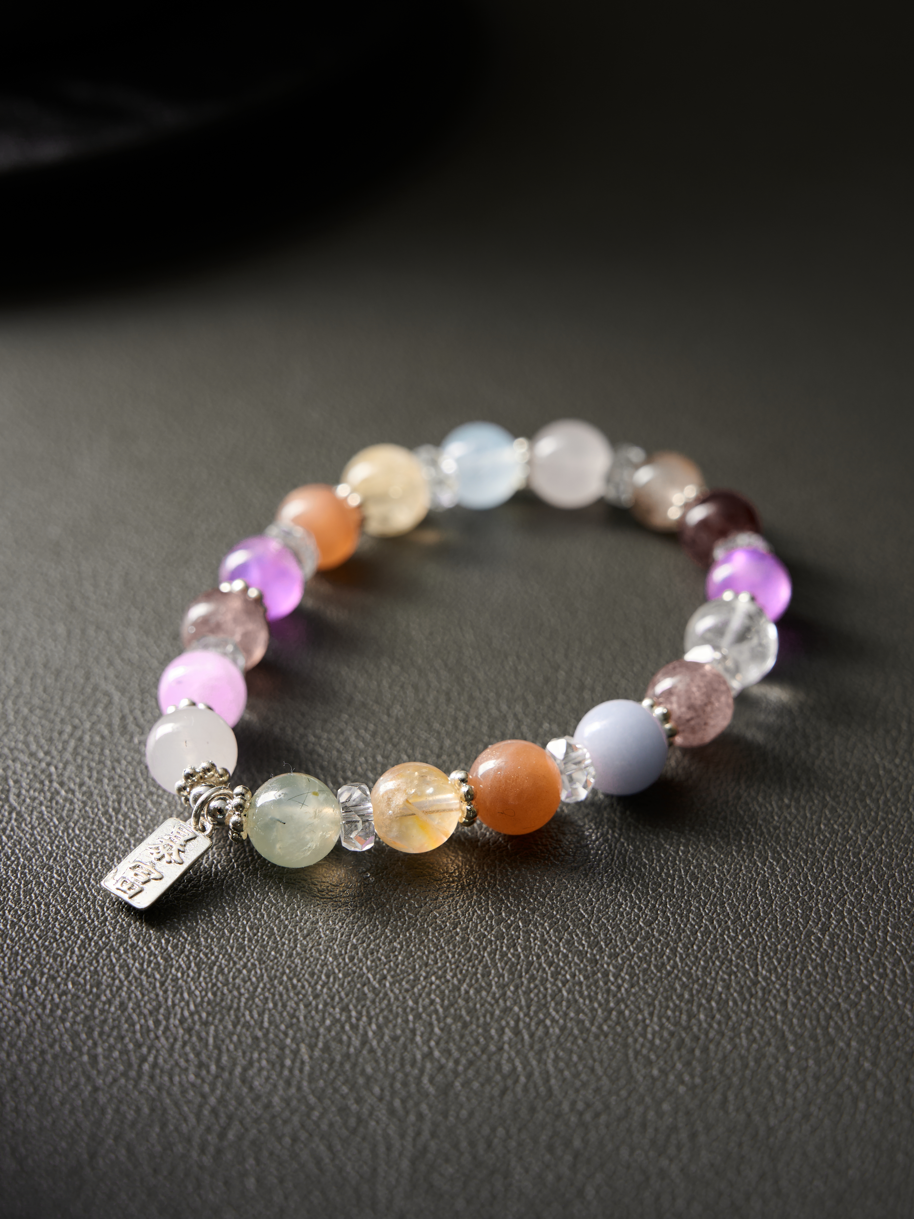 Diagonal flat composition highlighting kunzite pink and strawberry-quartz tones with silver spacers