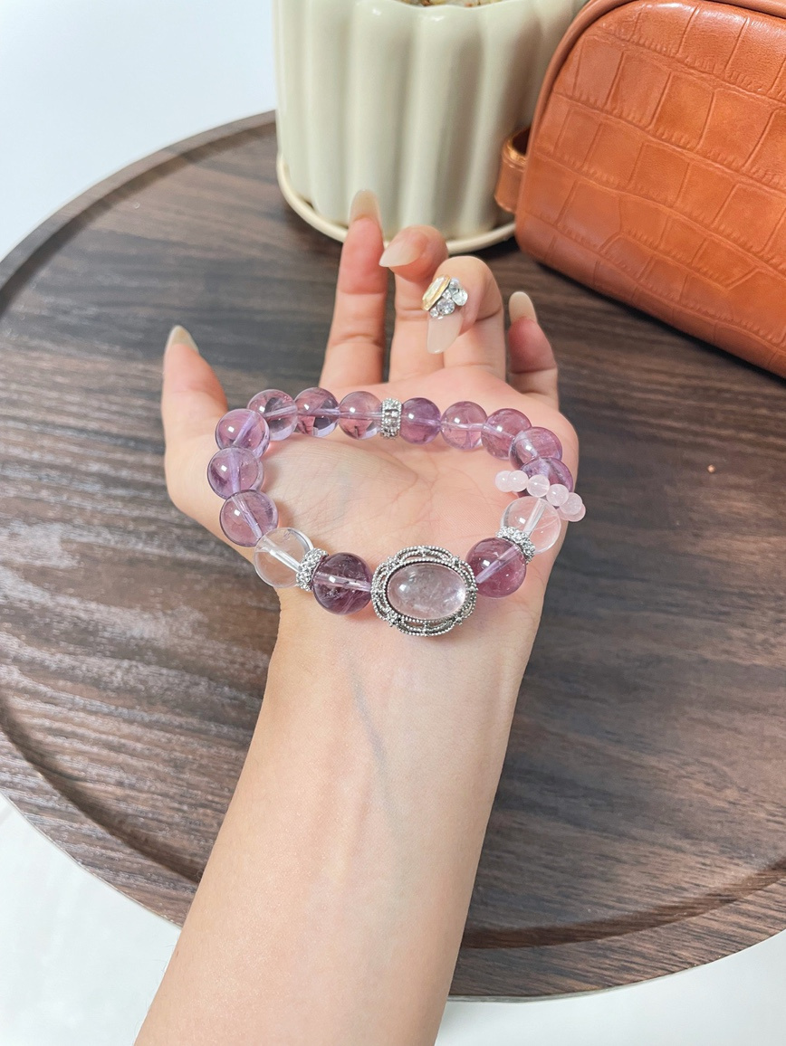 Amethyst and Clear Quartz bracelet resting on wooden table