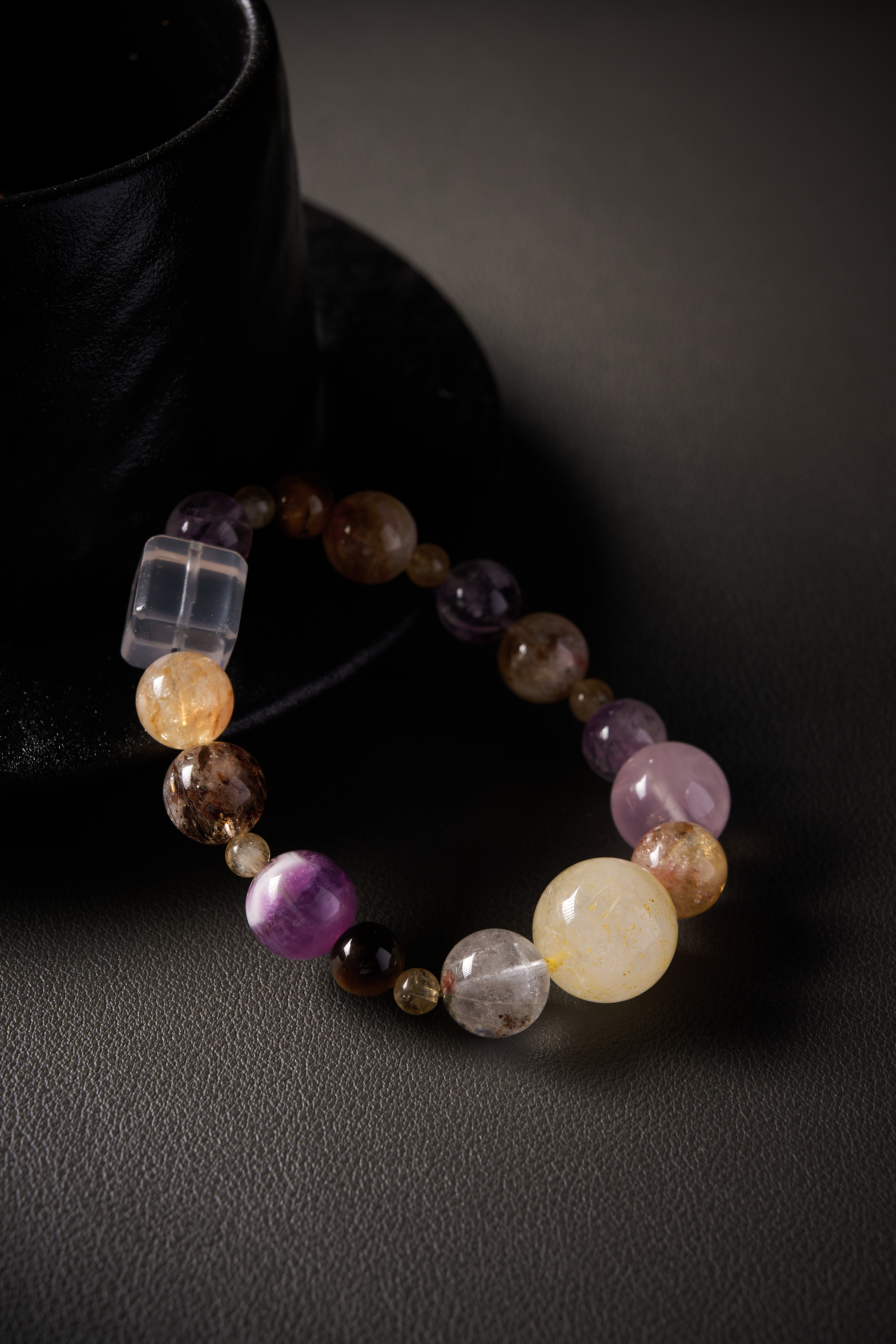 Texture highlight – tiger’s eye chatoyancy and rose quartz softness under soft light, natural patterns visible.