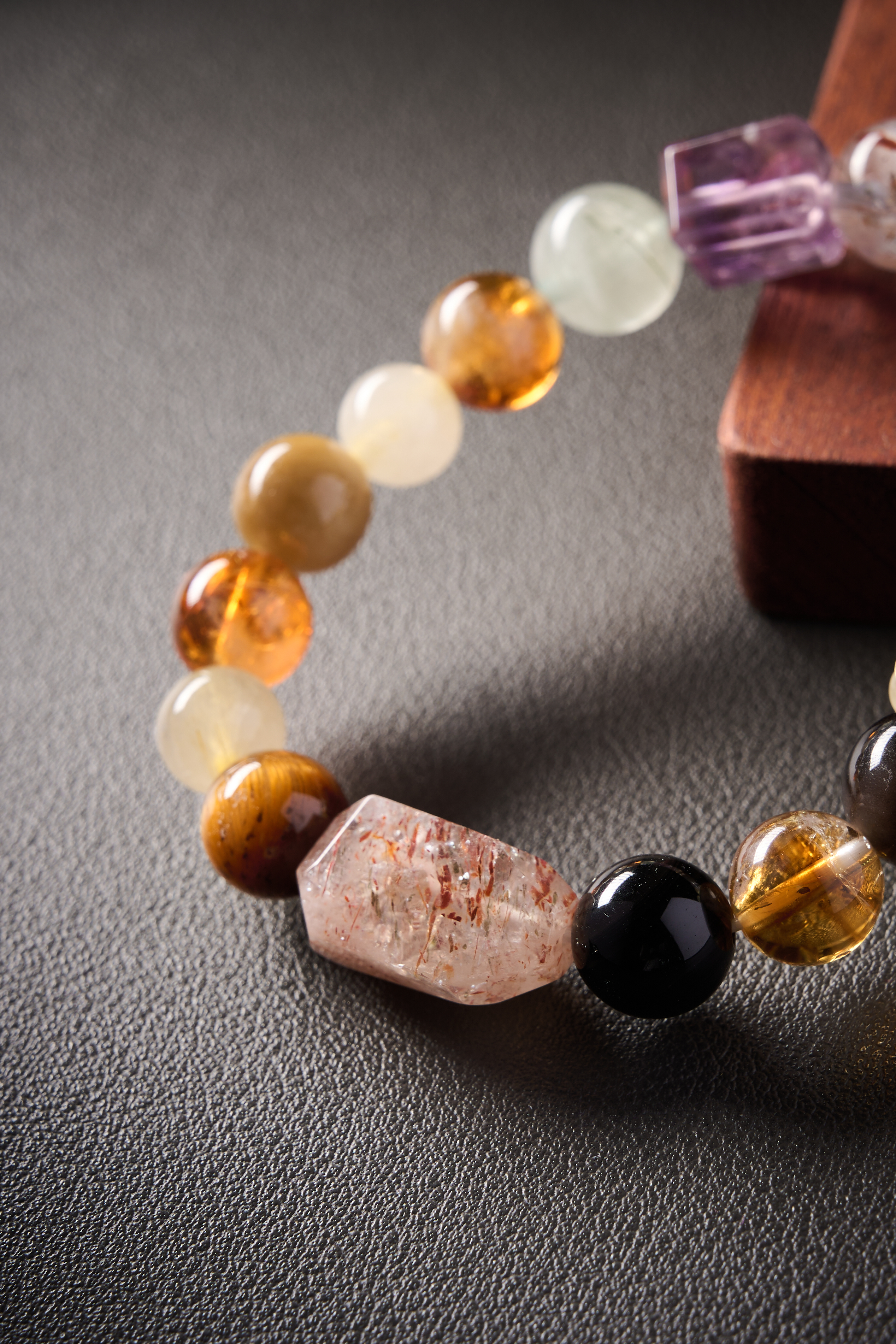 Texture highlight – faceted or cube clear quartz spacer surrounded by mixed gemstones, crisp transparency.
