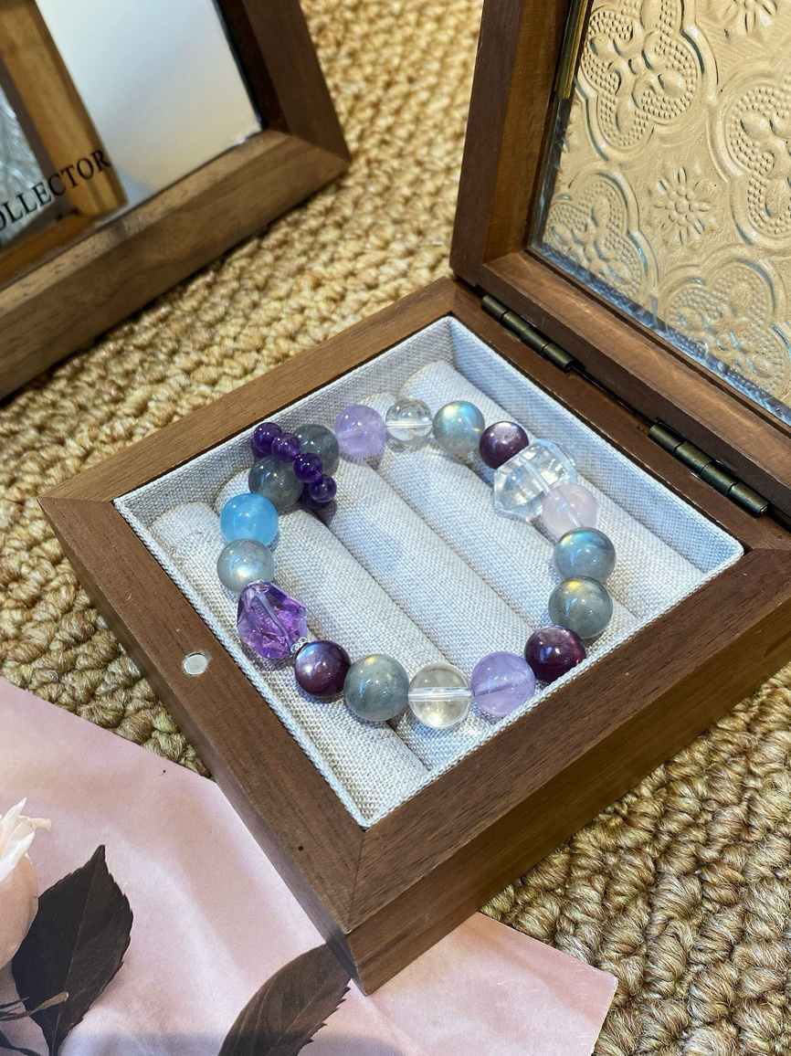 Amethyst, Clear Quartz and Aquamarine bracelet displayed in a wooden jewelry box