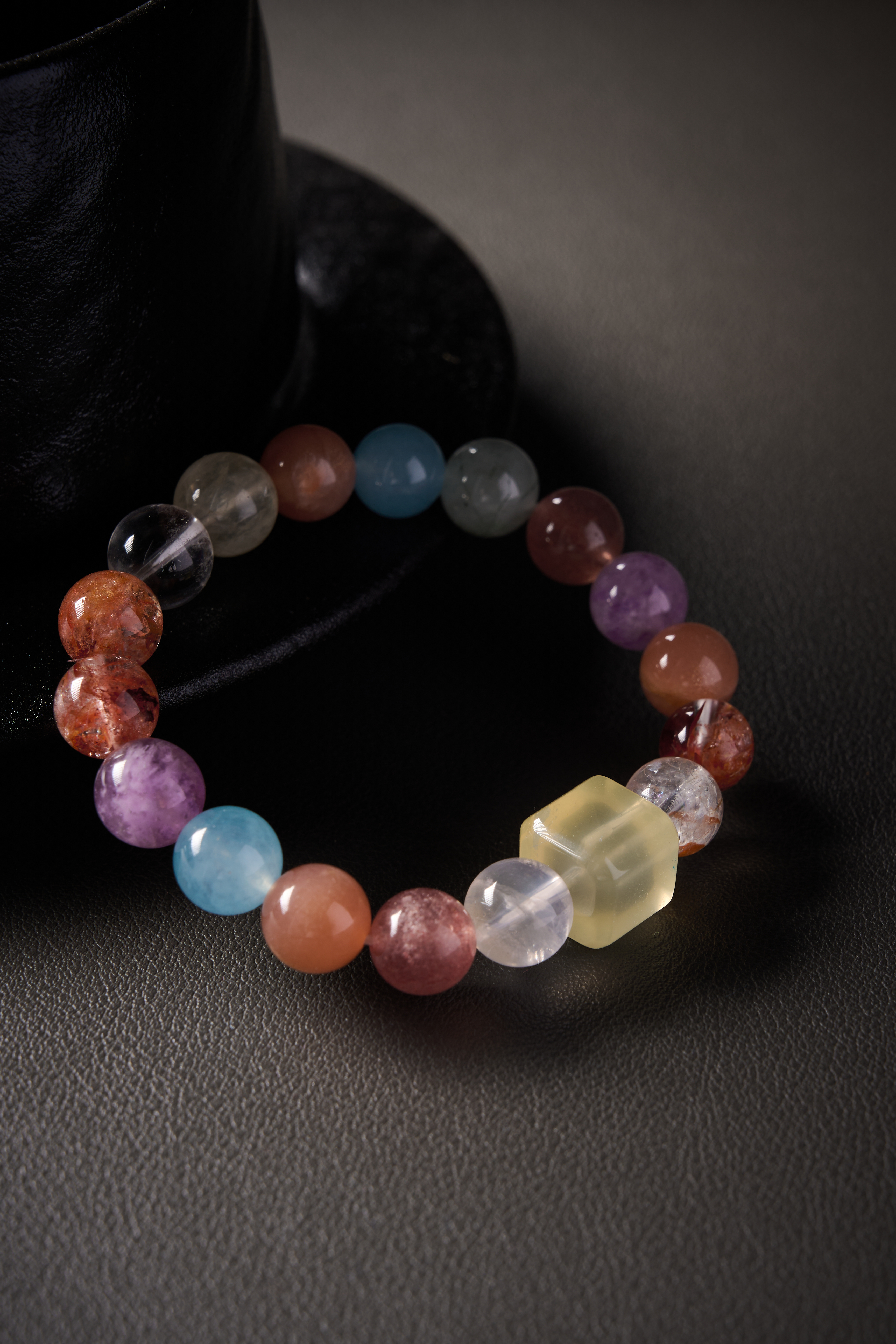 Centerpiece focus – square yellow jade spacer flanked by mixed round gemstones, crisp contours.