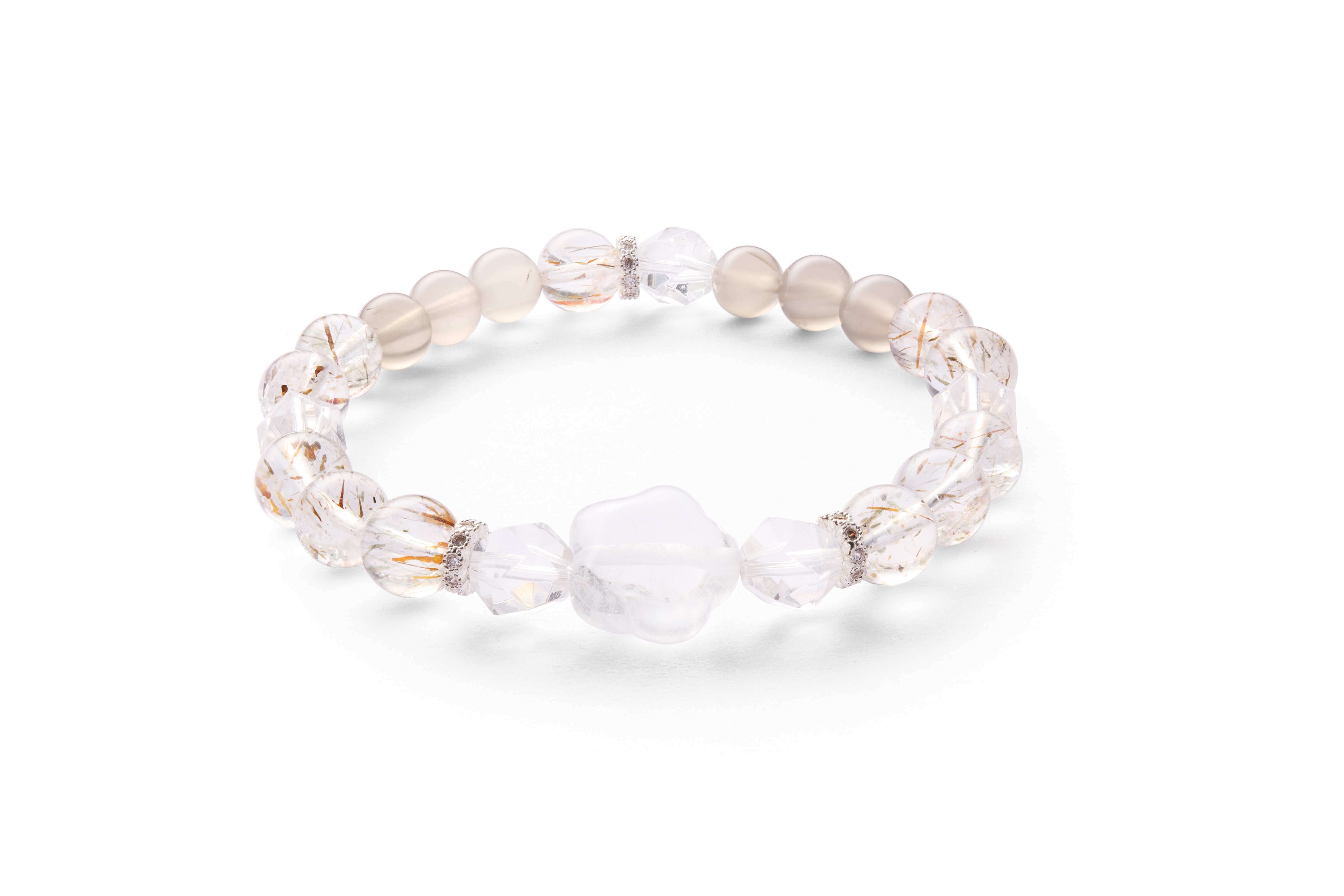Close flat lay emphasizing golden rutile needles inside quartz, polished round beads