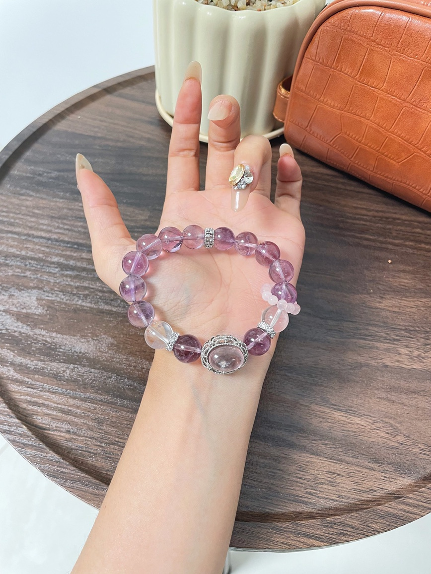 Stylish purple crystal bracelet with gemstone centerpiece on wrist