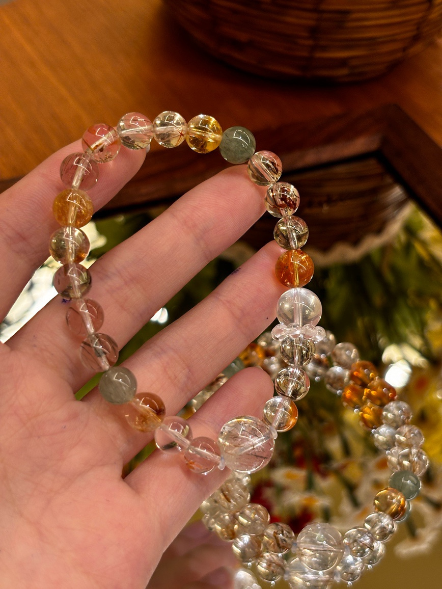 Super Seven crystal bracelet with golden and reddish inclusions displayed on hand