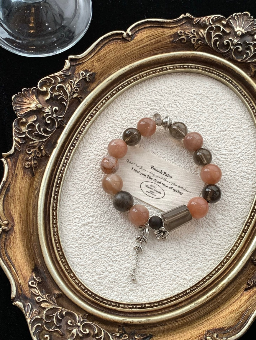 Crystal bracelet arranged in vintage gold frame for product display