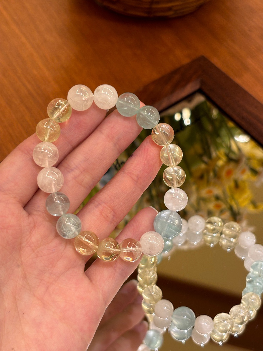 Close-up of pastel gemstone bracelet held in hand