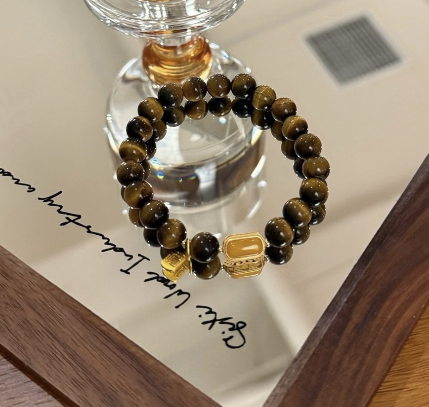 Smoky Quartz and Tiger’s Eye bracelet reflected in warm lighting
