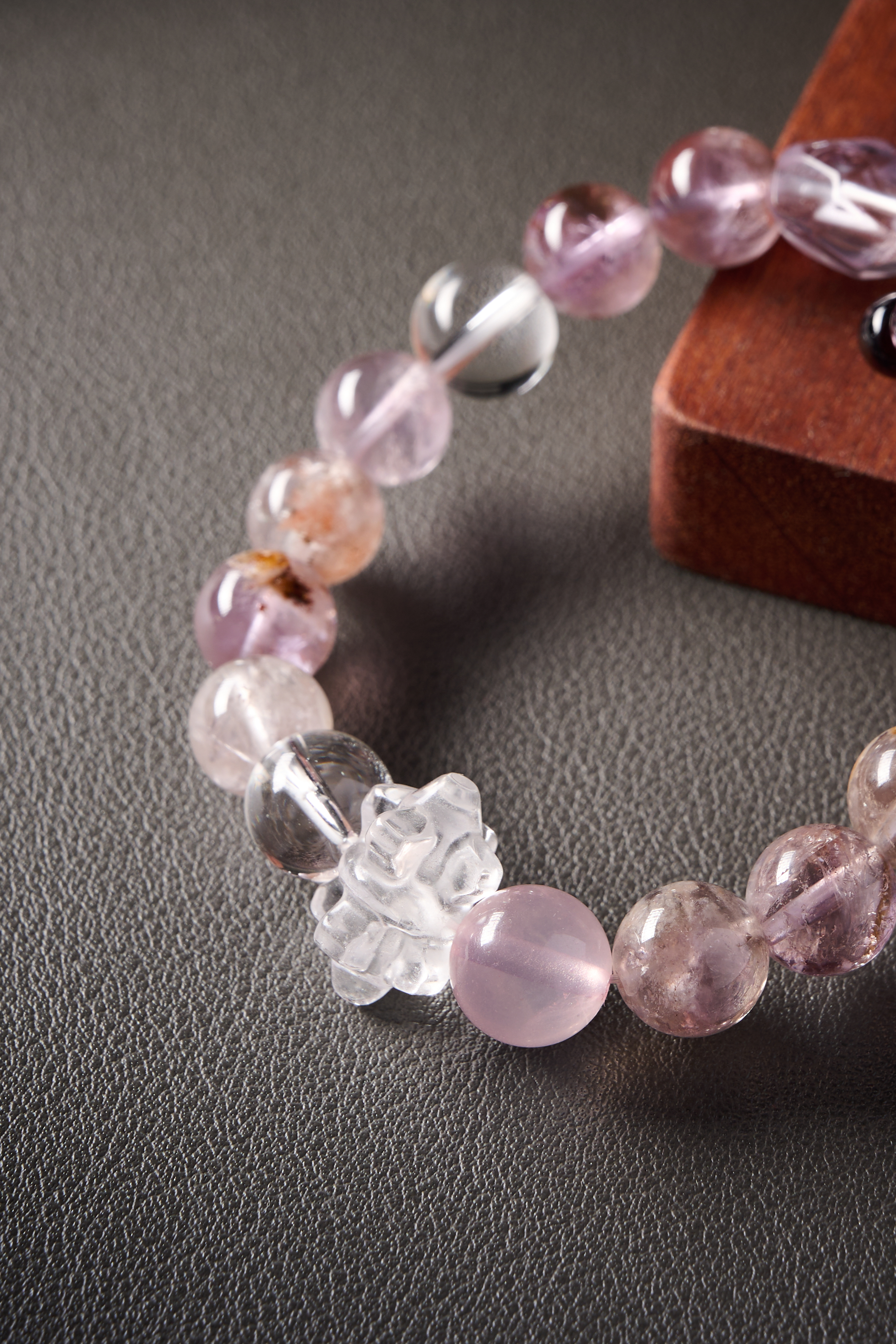 Close-up – amethyst bead with rich purple tone and glossy finish, natural inclusions visible.