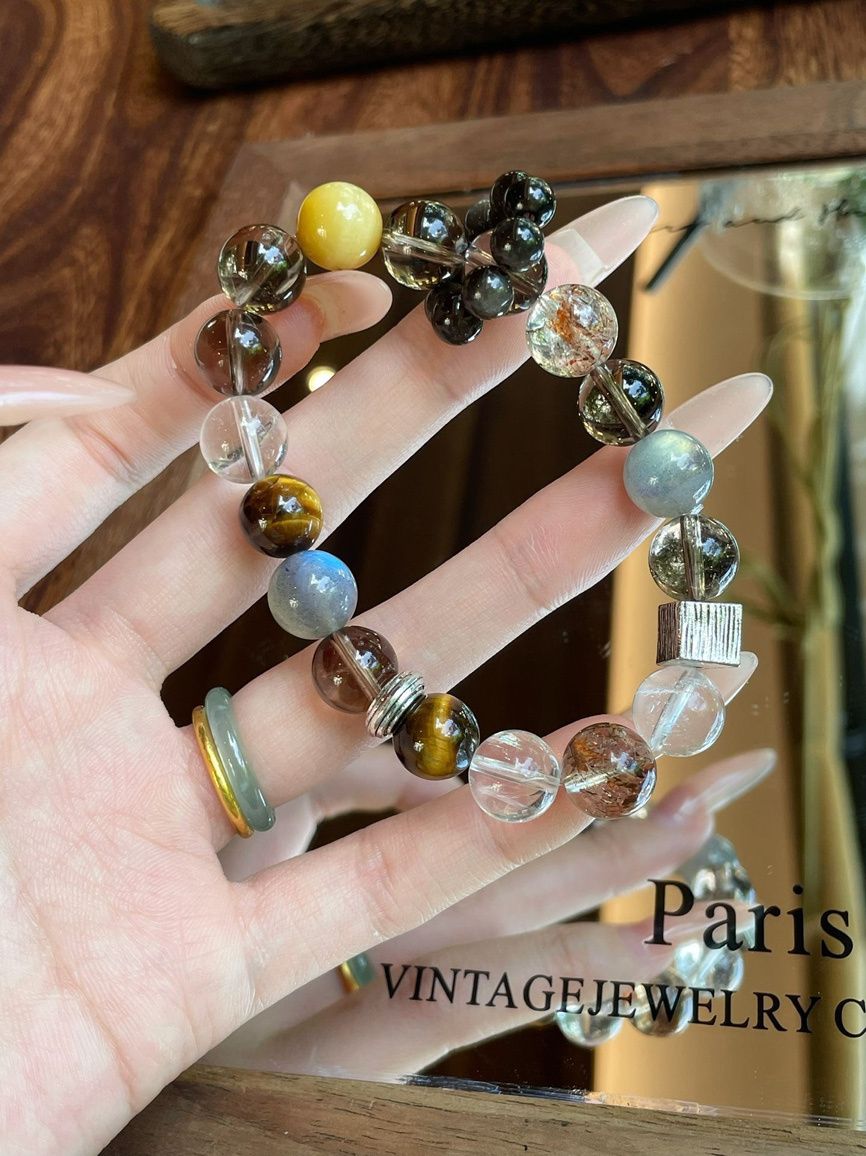 Close-up of multi-gemstone bracelet glowing under sunlight.