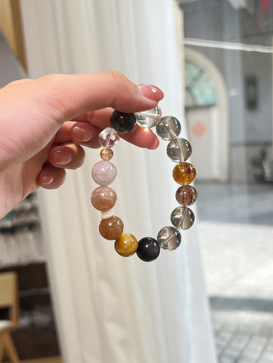 Hand holding multicolor crystal bracelet close-up view