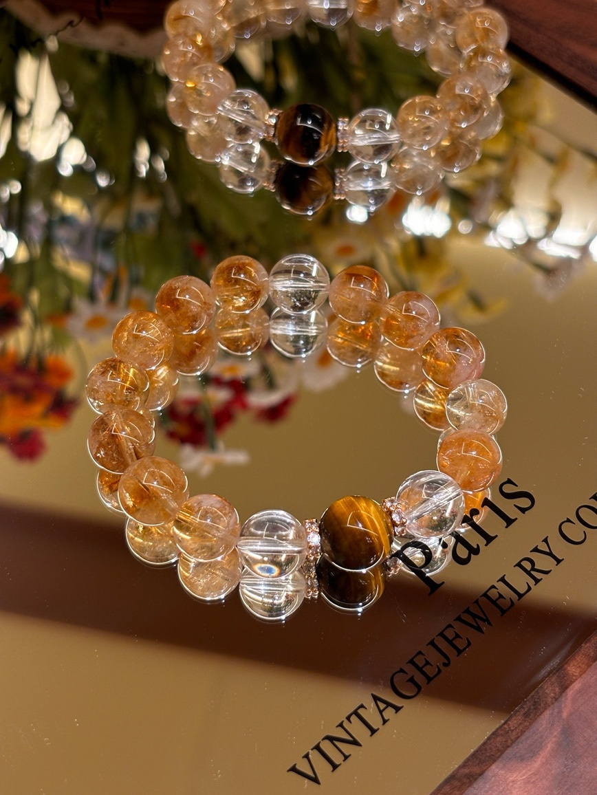 Citrine, Tiger’s Eye, and Clear Quartz bracelet displayed on a mirror surface