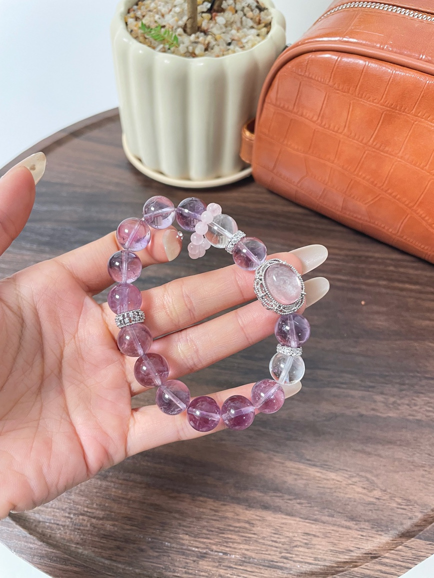 Close-up of Amethyst and Kunzite beads under soft light