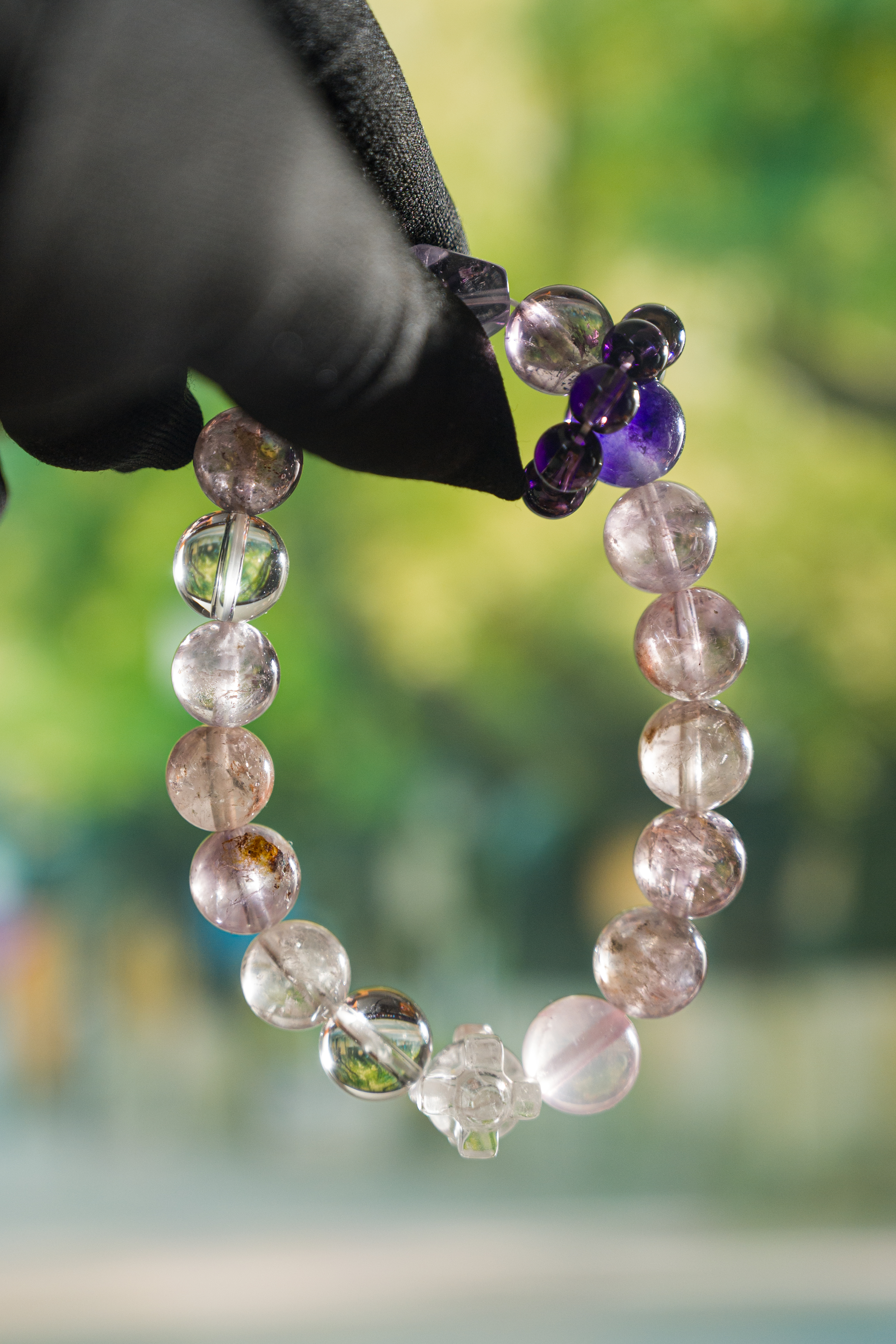 Wrist-on shot – amethyst & rose quartz bracelet worn on hand, minimalist everyday styling.