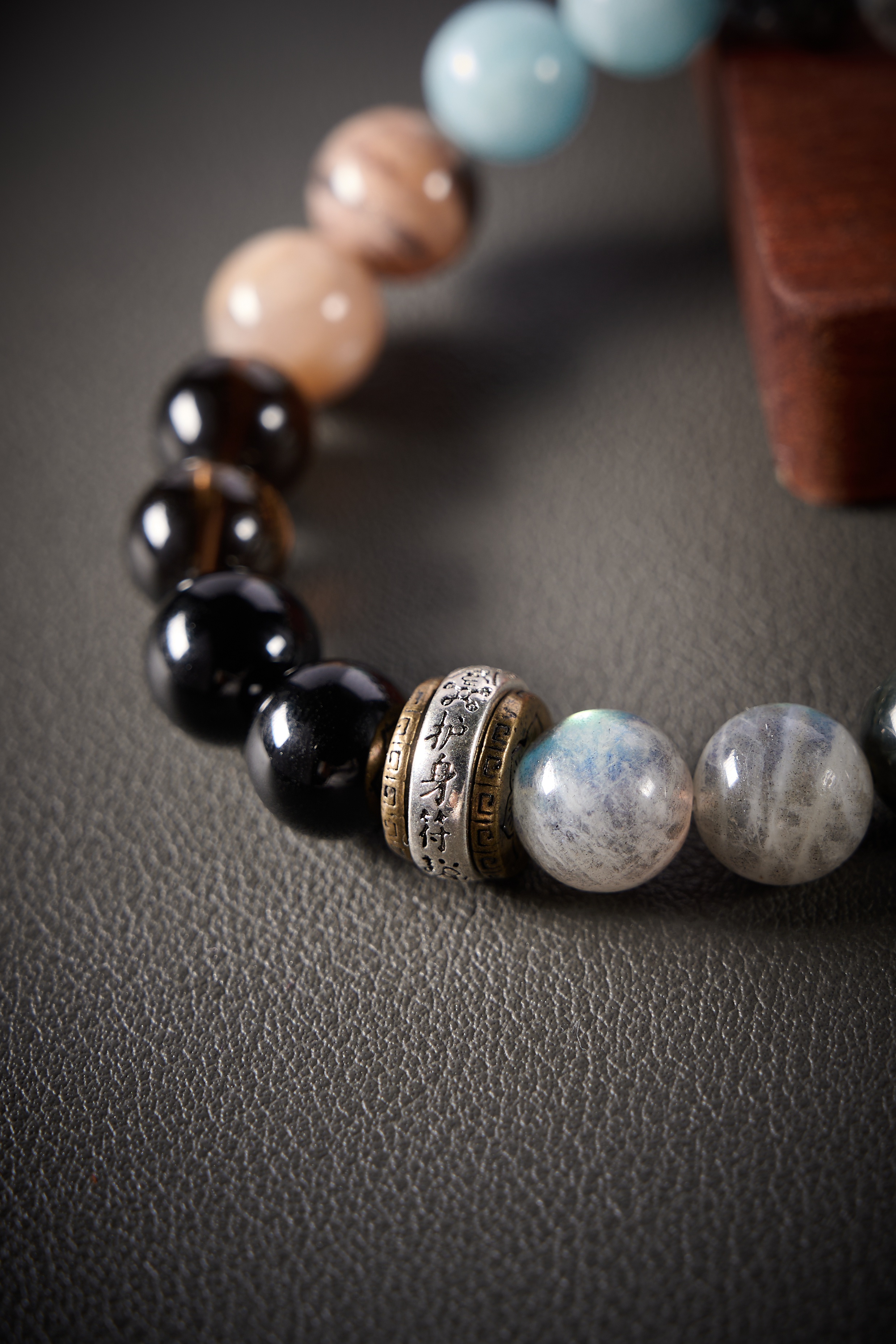Close-up – glossy black obsidian beads showing high shine and smooth surface, grounding crystal detail.
