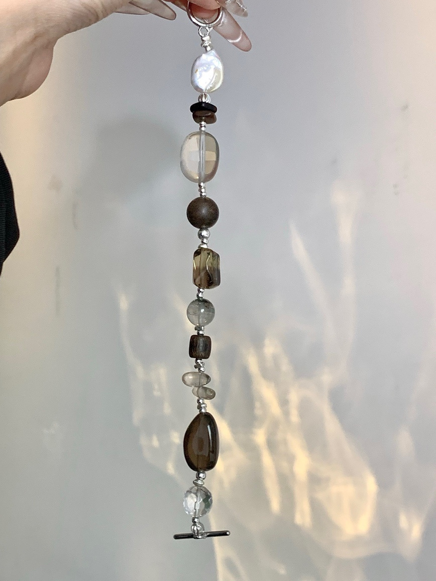 Bracelet laid on beige fabric surface under warm light
