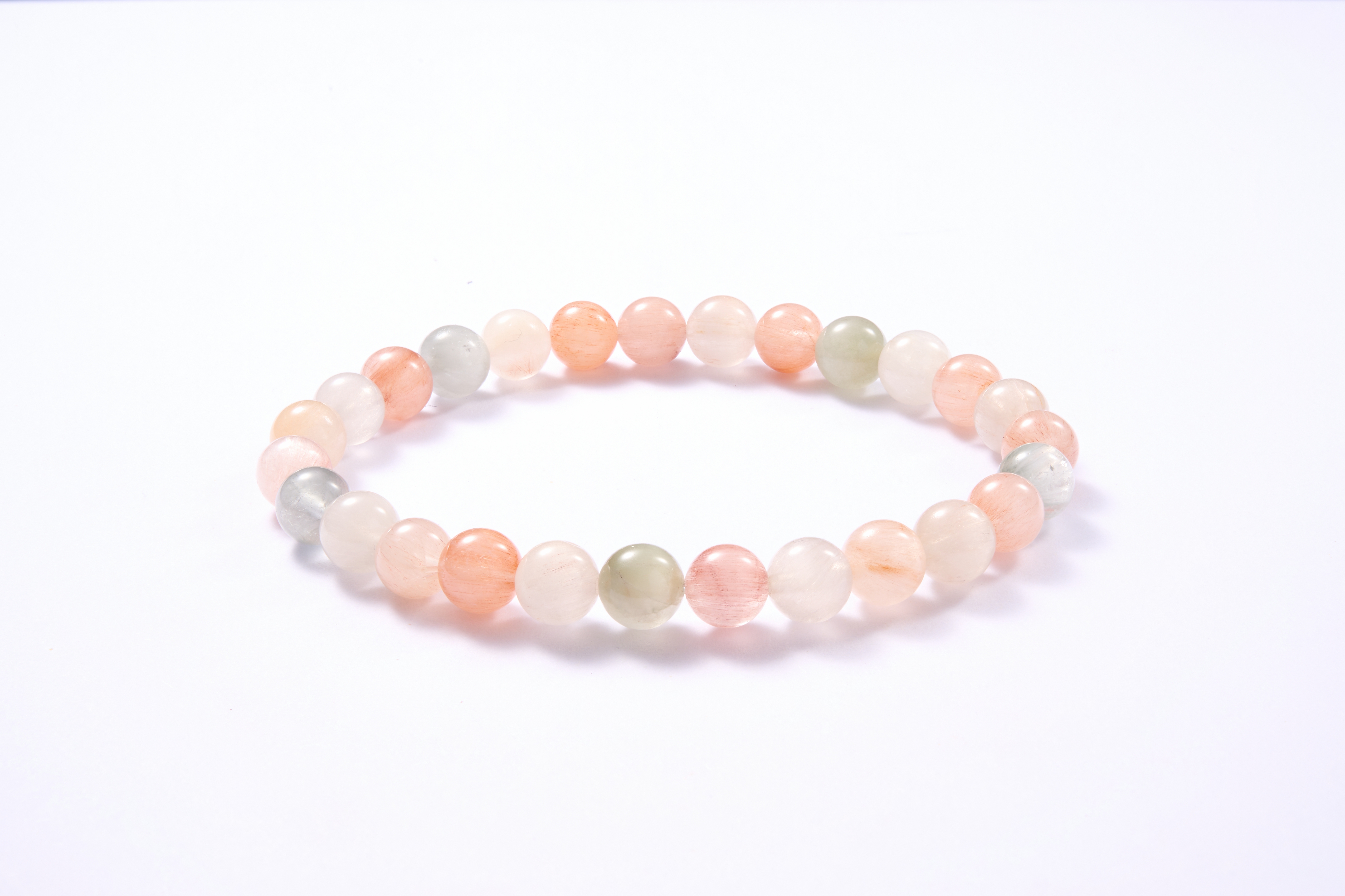 Angle close-up of end beads and spacer, clear quartz texture.