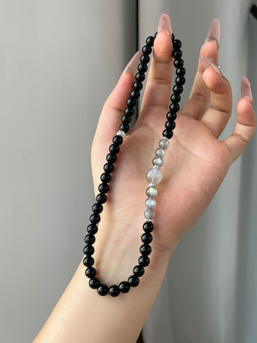 Close-up of natural Obsidian and Moonstone beads showing color contrast