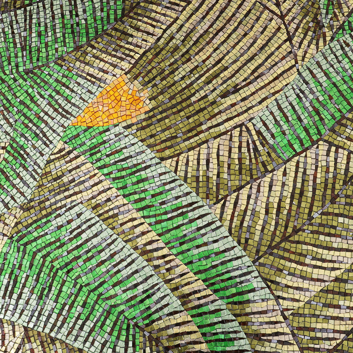 Close-up of green leaf mosaic artwork with layered leaves and orange highlights