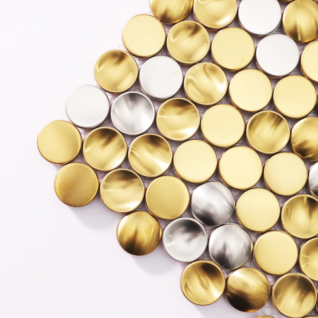 Close up of 3D mixed gold and silver penny round stainless steel tiles.