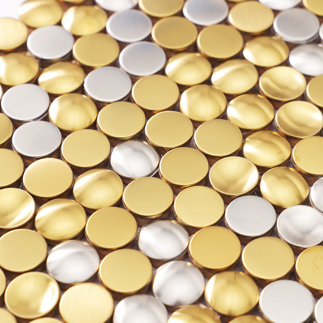 Detailed surface view of mixed metallic gold and silver penny round mosaic.