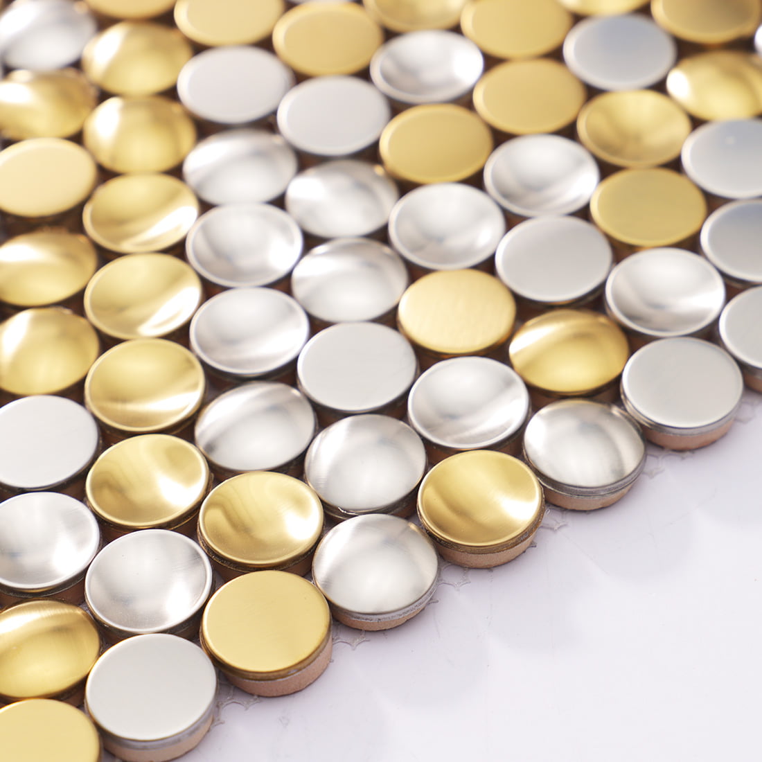 Detail of 3D concave gold and silver metal mosaic tiles showing depth.