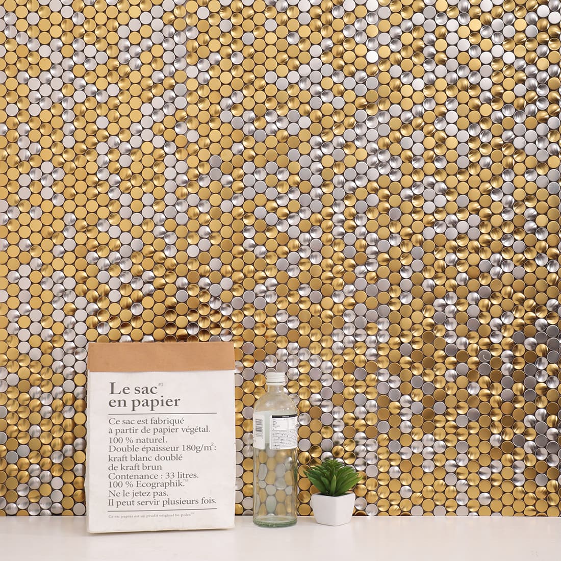 Interior wall decorated with mixed gold and silver penny round mosaic tiles.