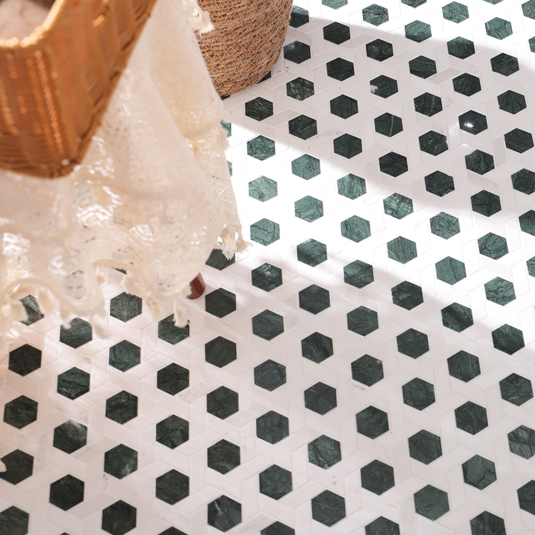 Installed green hexagon mosaic floor with white background in a styled room scene