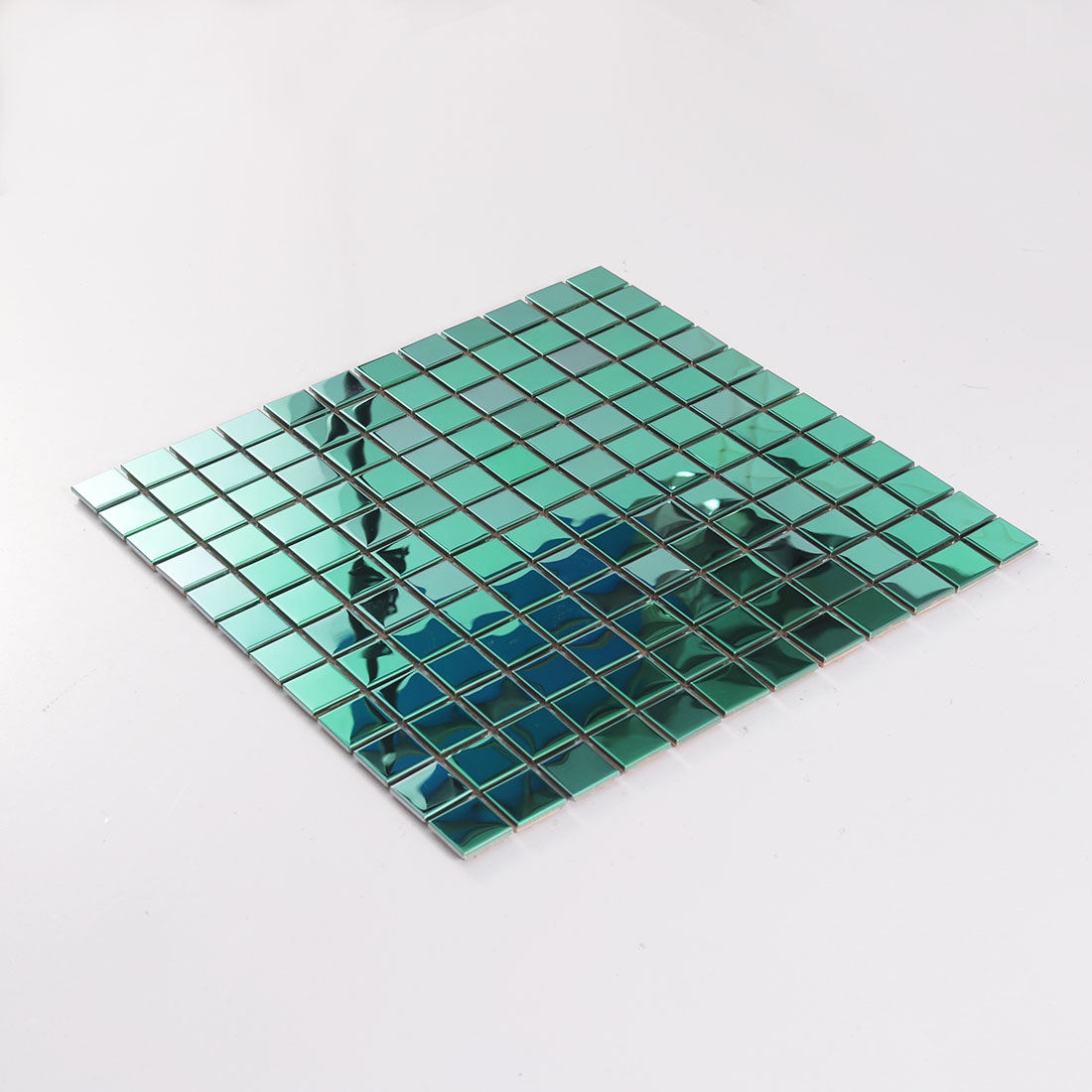 Angled view of green square stainless steel mosaic tile sheet