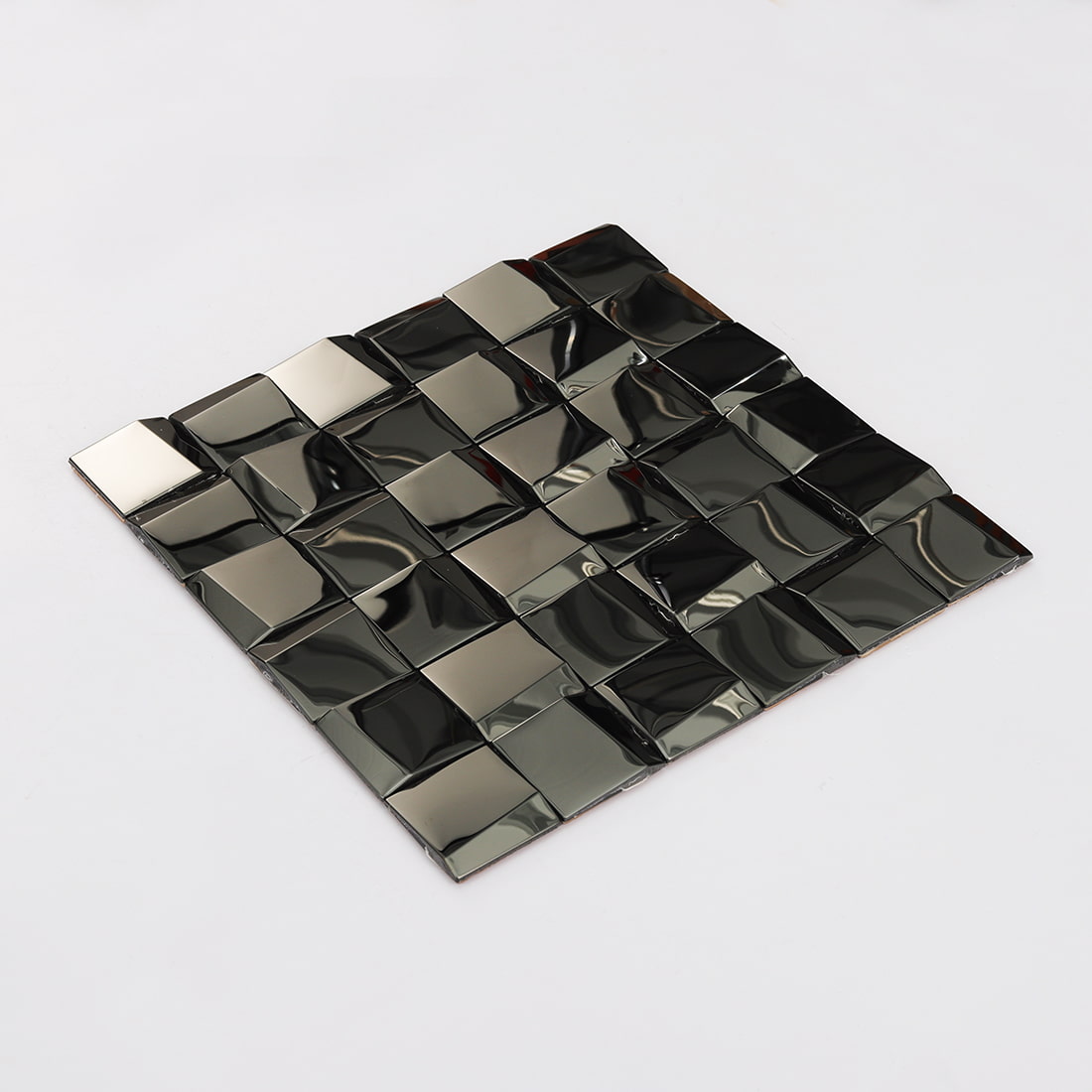 Angled shot of a black 3D square mosaic tile sheet on a white background.