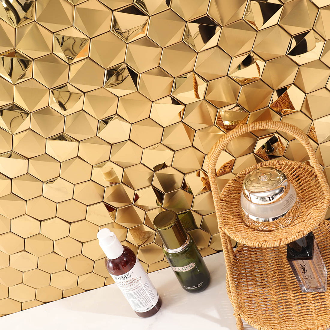 Angled perspective of a gold 3D hexagon feature wall with cosmetics.