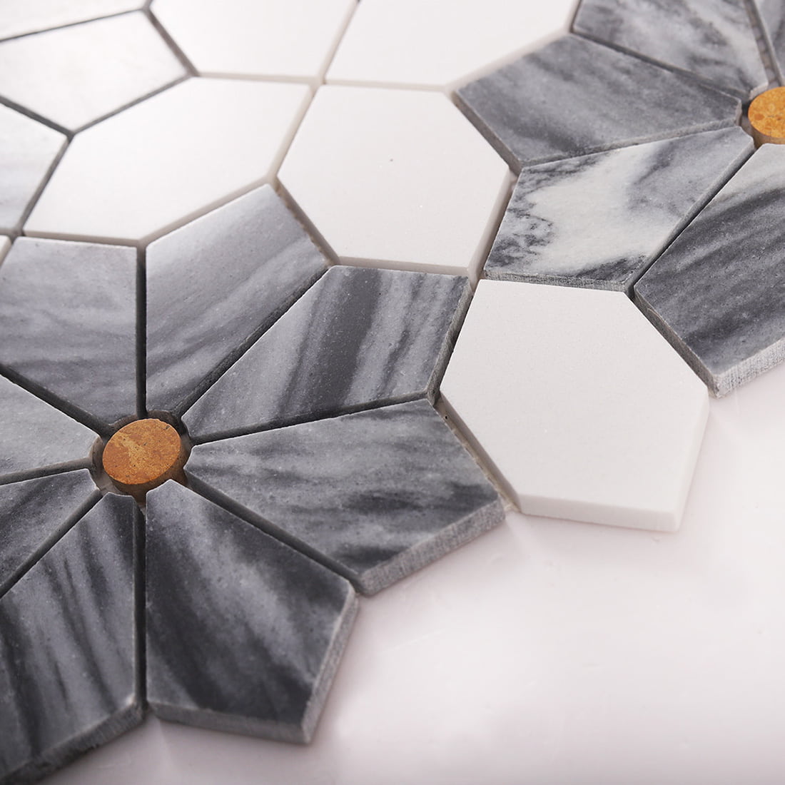 Angled view showing tile thickness and texture on a gray marble mosaic sheet