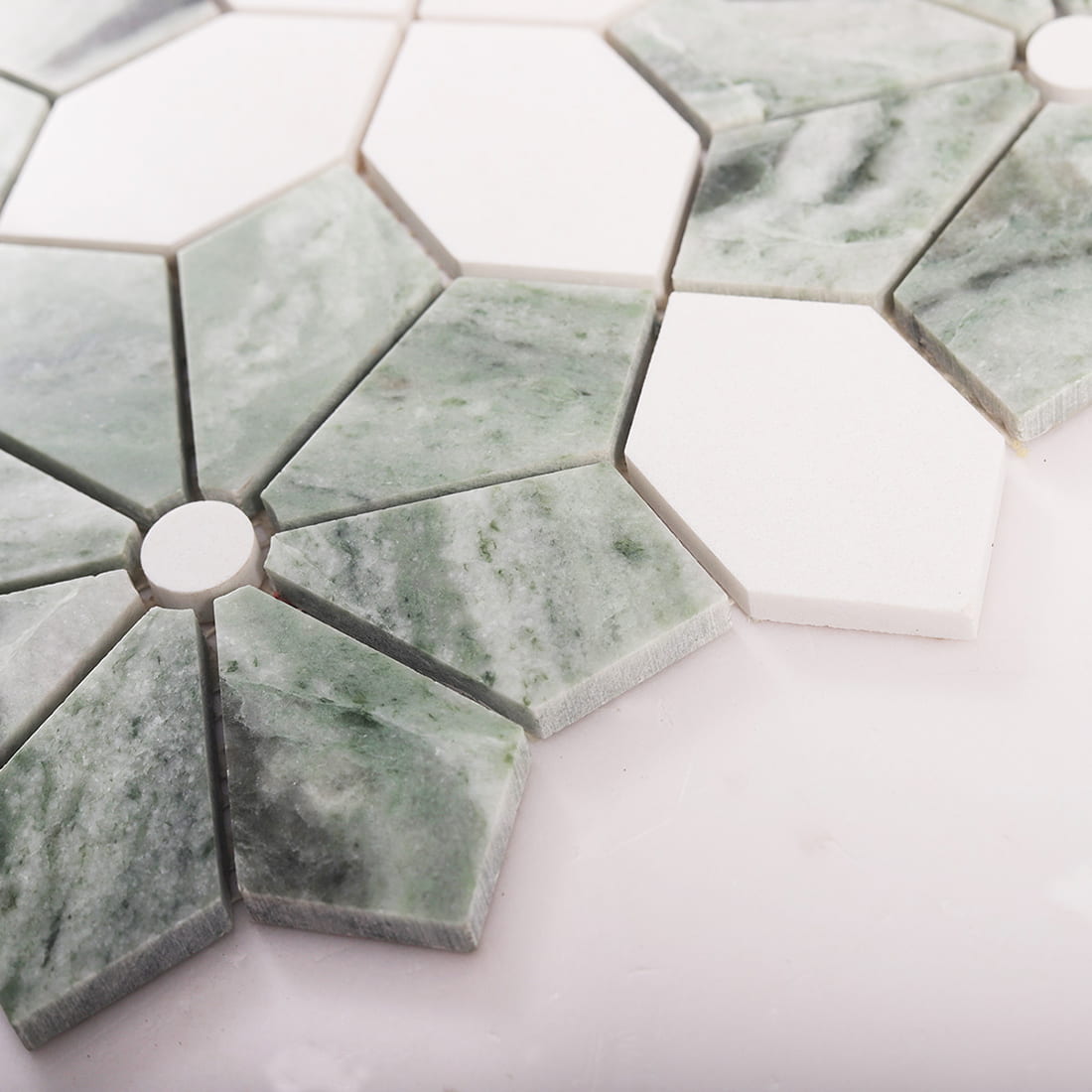 Angled view showing thickness and texture on a green marble mosaic sheet