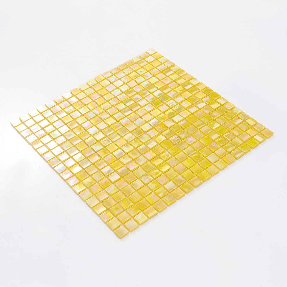Angled view of soft golden yellow iridescent glass mosaic tile sheet with pearlescent finish