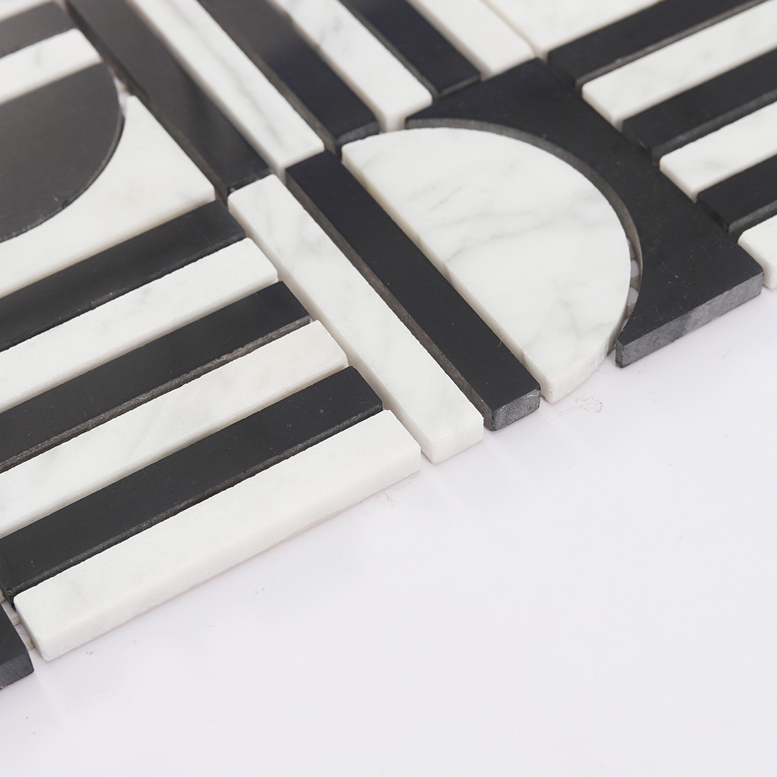 Angled edge view showing the thickness of the marble mosaic.