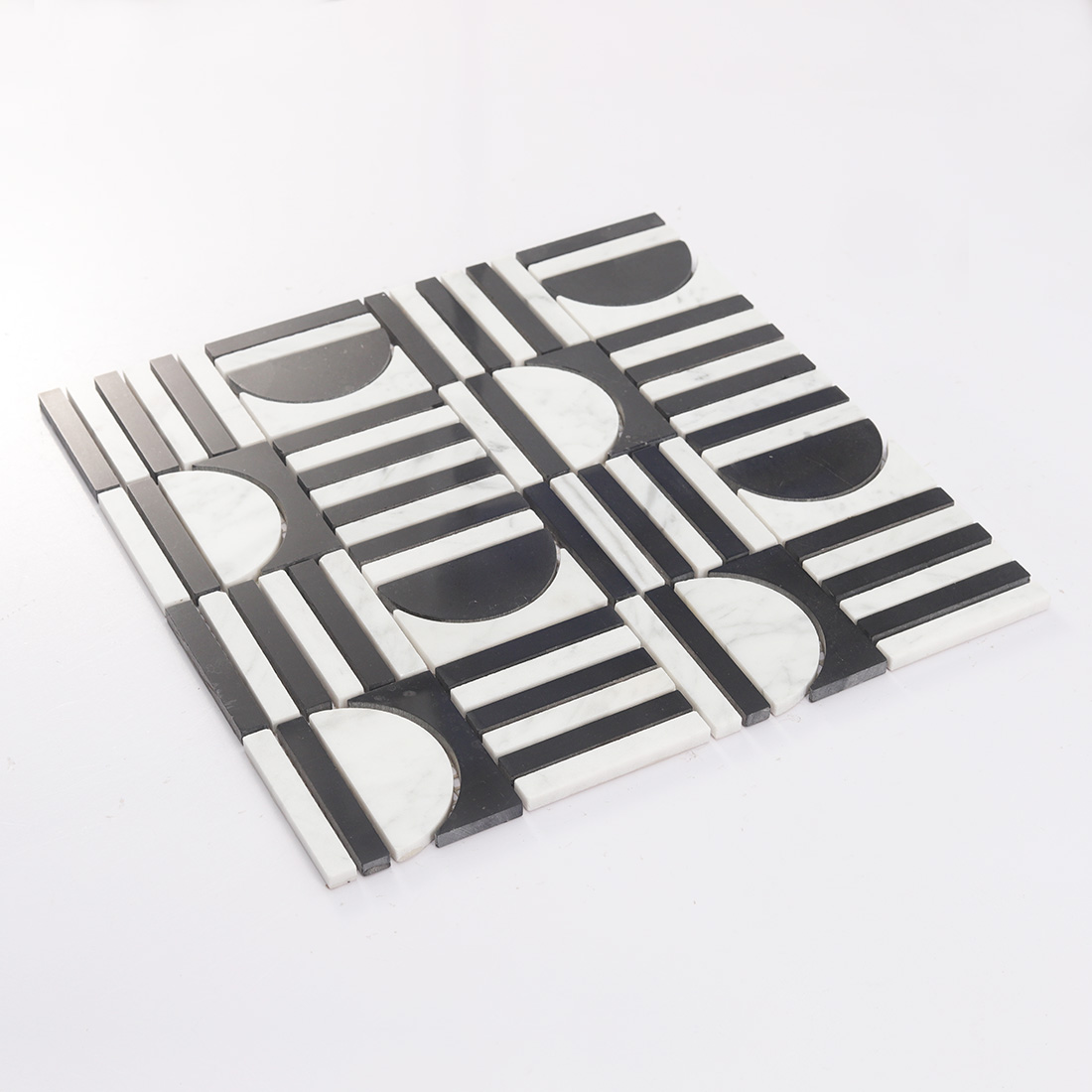 Angled perspective of a black and white marble mosaic tile.