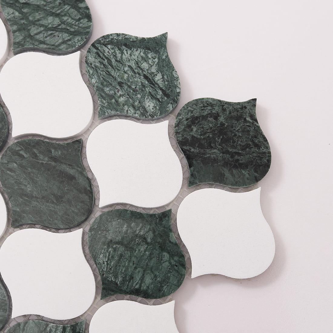 Corner close-up showing green marble and white arabesque shapes