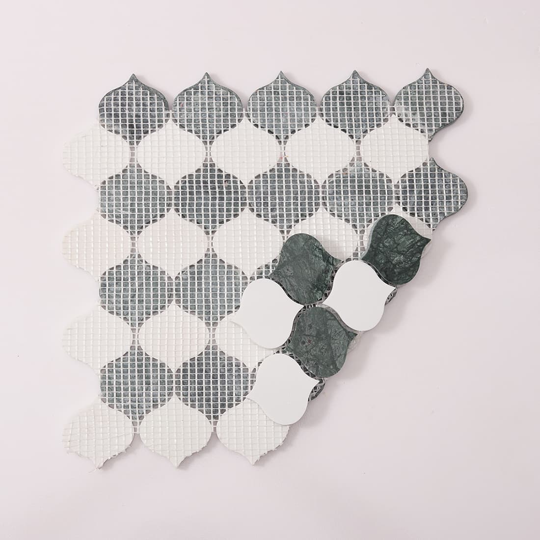 Back view showing mesh backing of green and white arabesque marble mosaic