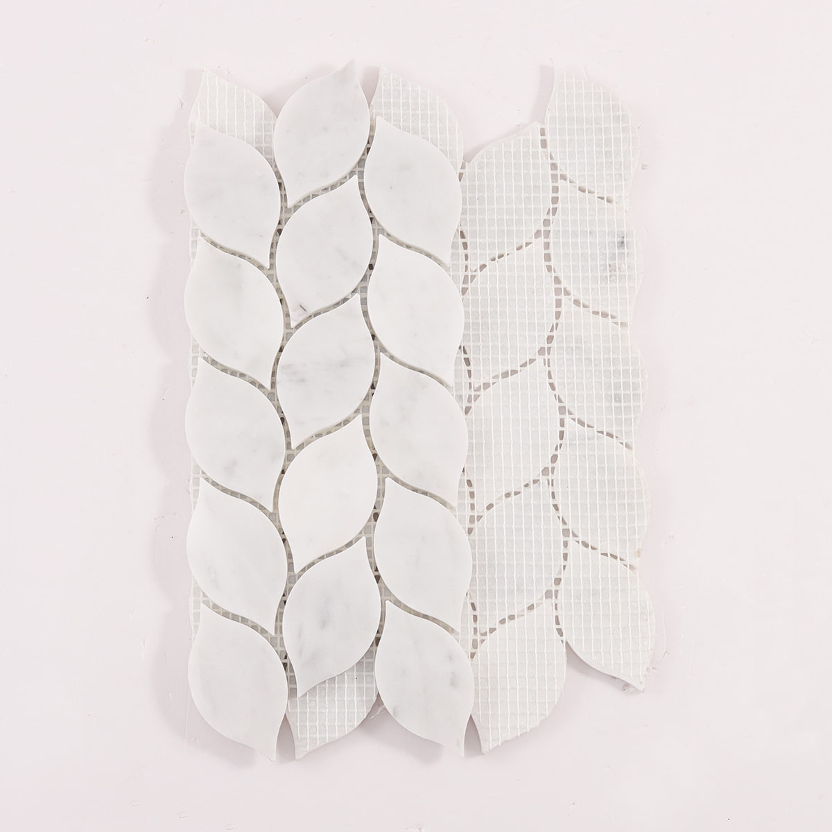 Back view of white marble leaf mosaic tile sheet with mesh backing
