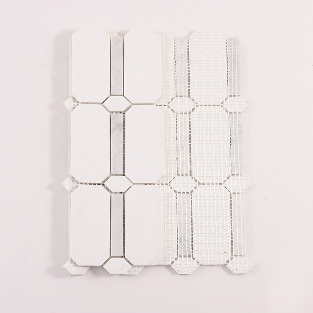 Back view of white octagon mosaic tile sheet with mesh backing
