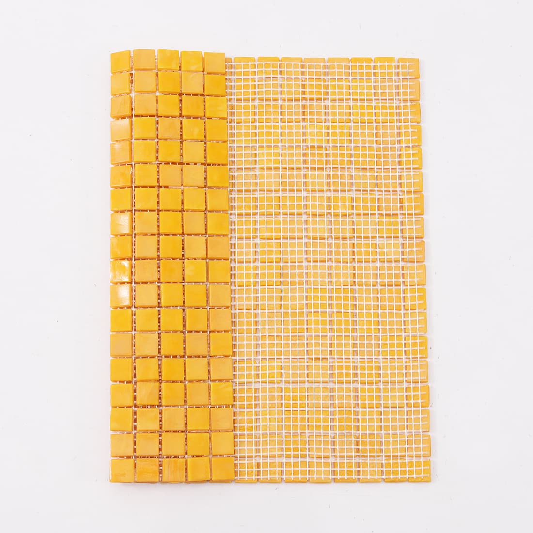 Yellow mosaic tile sheet partially folded to reveal the white mesh backing material.
