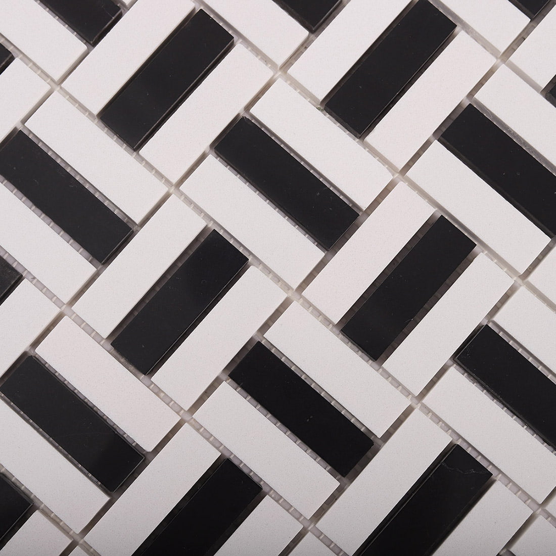 Macro view showing depth of black and white basket weave mosaic tiles