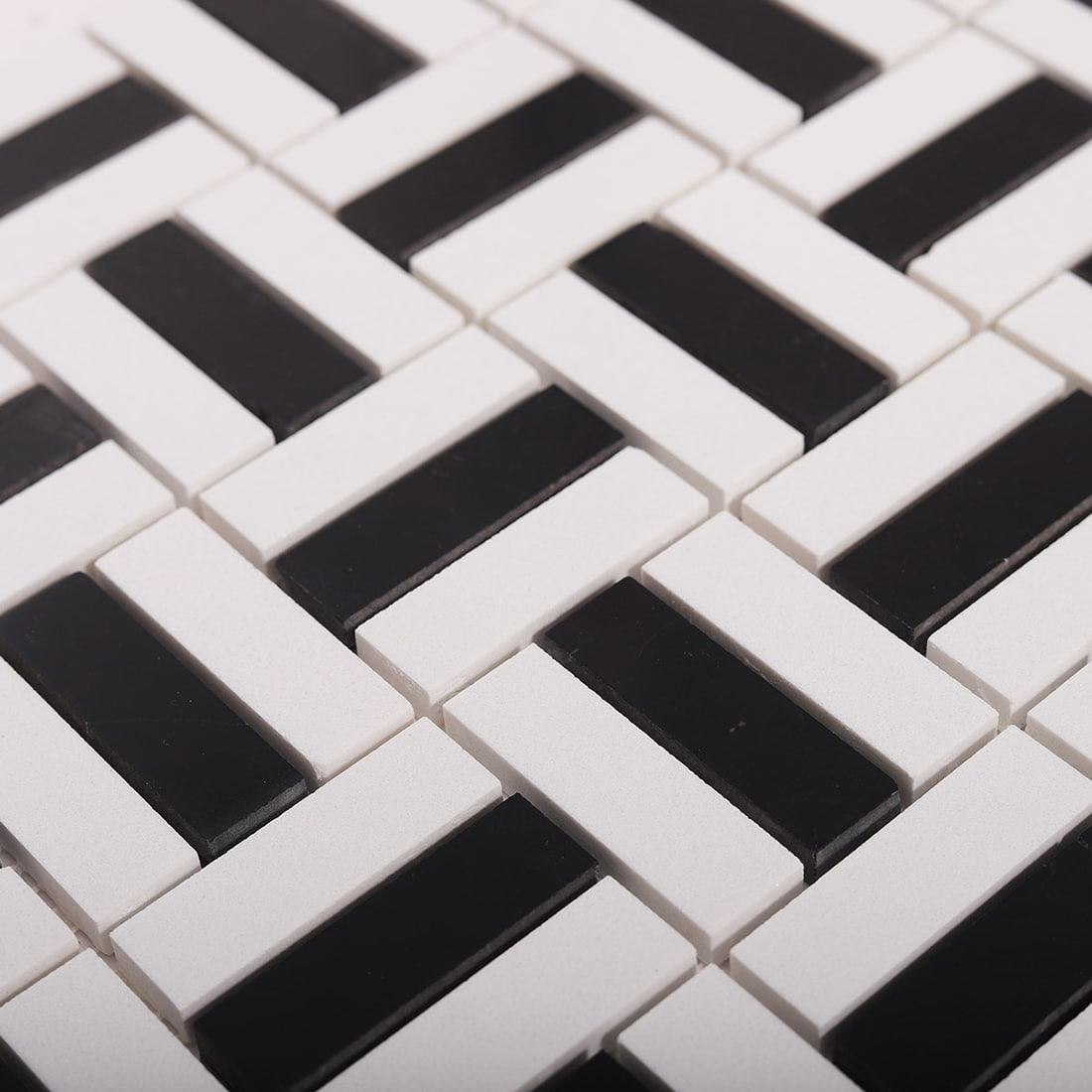 Close-up of interlocking black and white basket weave mosaic pattern