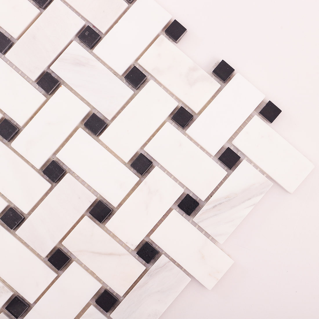 Diagonal close-up of marble basket weave mosaic highlighting woven pattern.