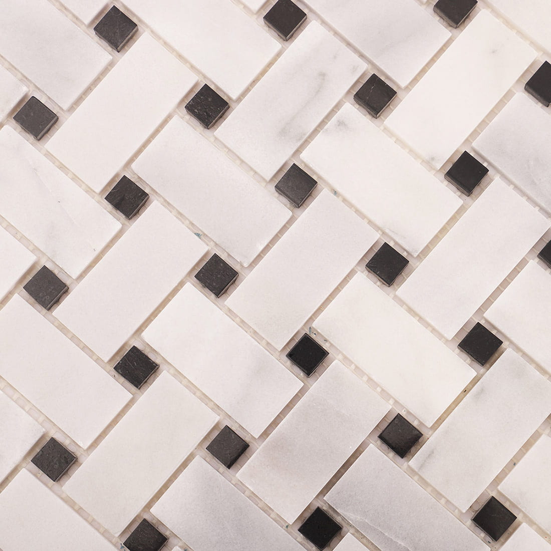 Close-up of black dot accent pieces within the Carrara white basketweave pattern.