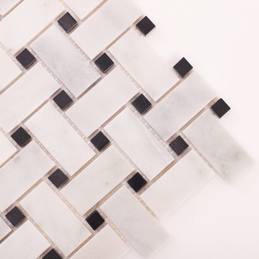 Diagonal close-up highlighting the woven layout of Carrara white marble mosaic.